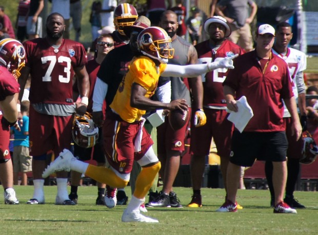 Robert Griffin III eludes defenders. Photo by Jake Russell.