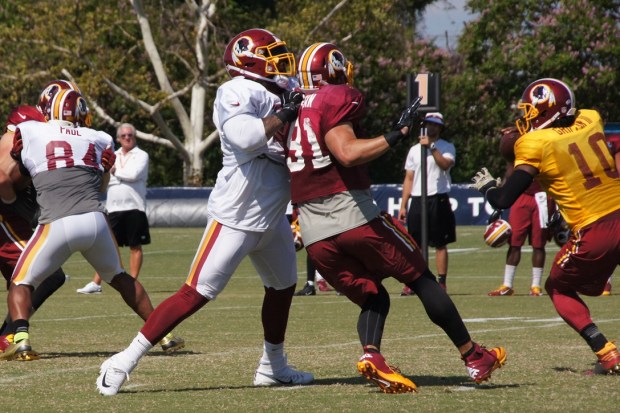 Offensive tackle Trent Williams blocks linebacker Ryan Kerrigan. Photo by Jake Russell.